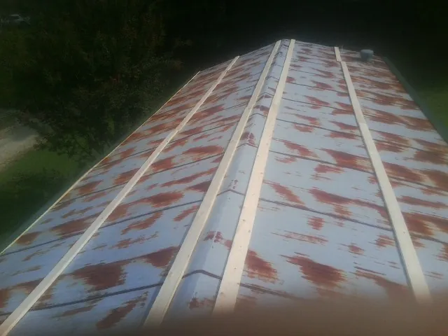 Rusted metal roof panels with new wood purlins before replacement — Storm Damage Roof Repair in Glenburn by Roofing Brothers
